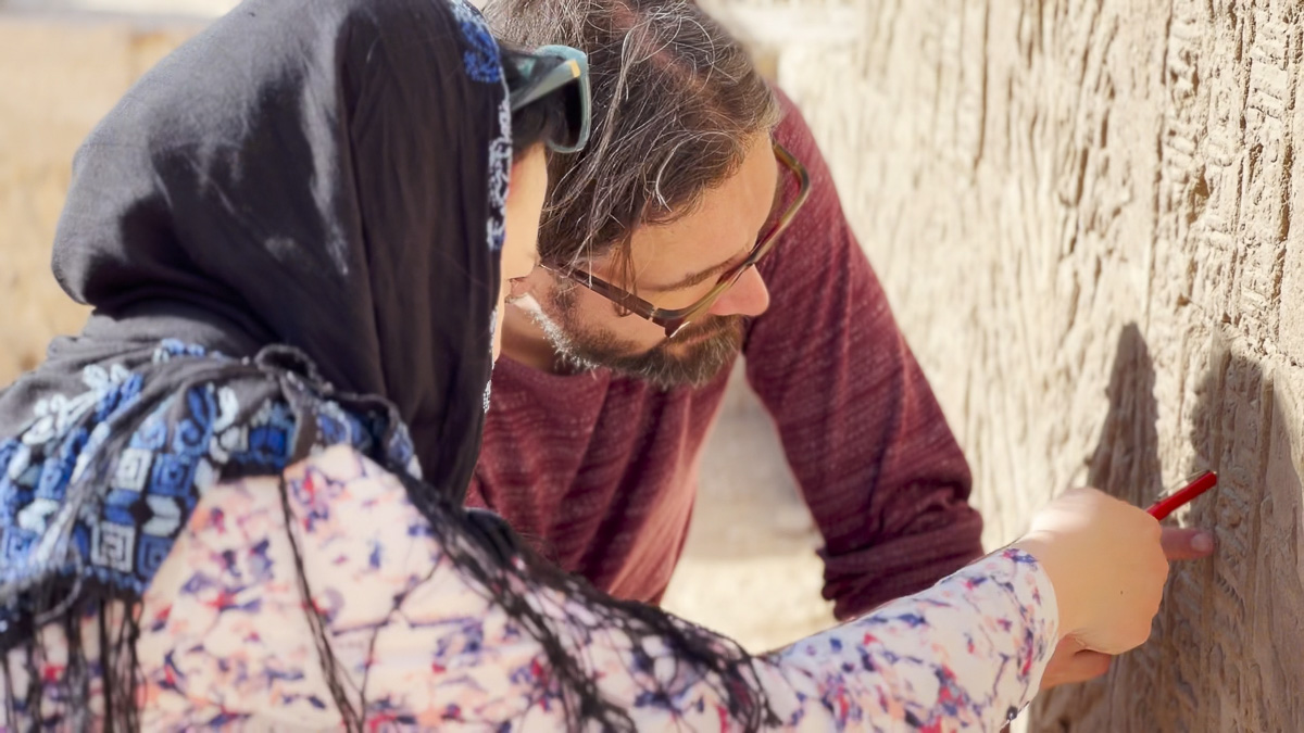 Egyptologists Diana Míčková (Czech Academy of Sciences) and Dr Martin Pehal (Charles University) check inscriptions at the ruins of the laboratory of the temple dedicated to the god Min-Re at Athribis. Photo by Sean Coughlin.